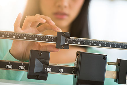 woman on scale measuring weight